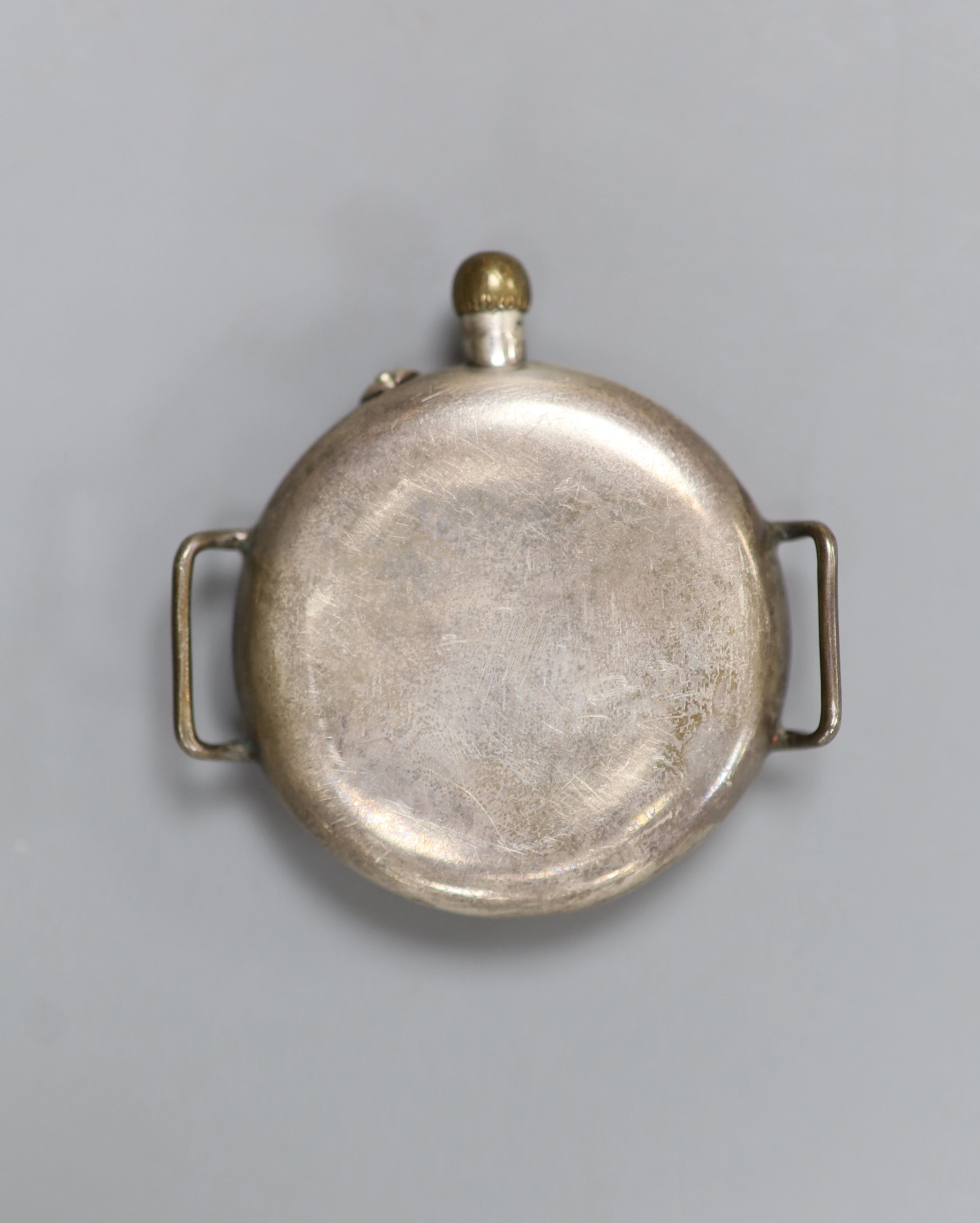 An early 20th century white metal Borgel? cased manual wind strapless wrist watch, with black dial.